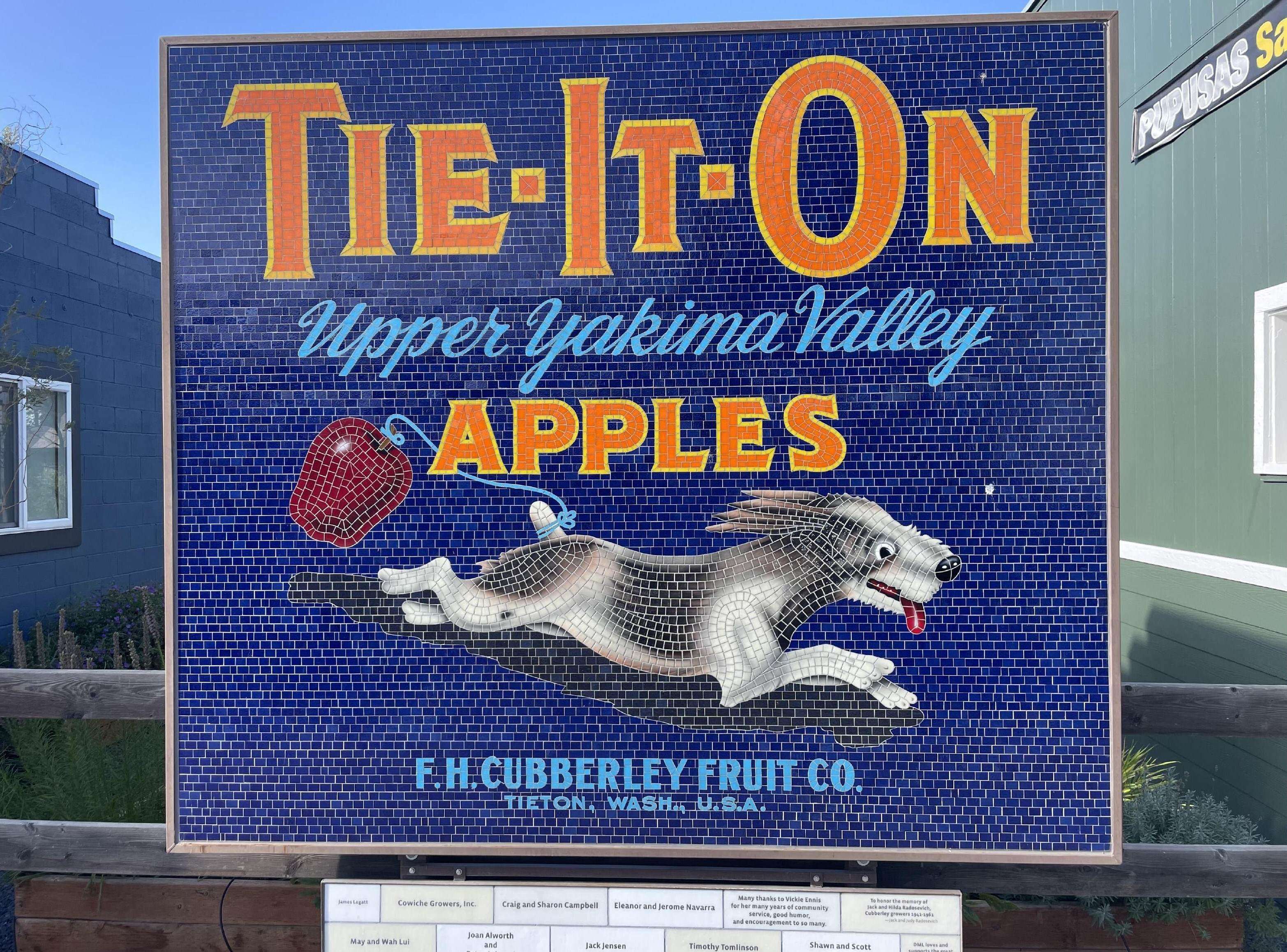 Tieton – Upper Yakima Valley Apples” with a leaping dog chasing a red apple