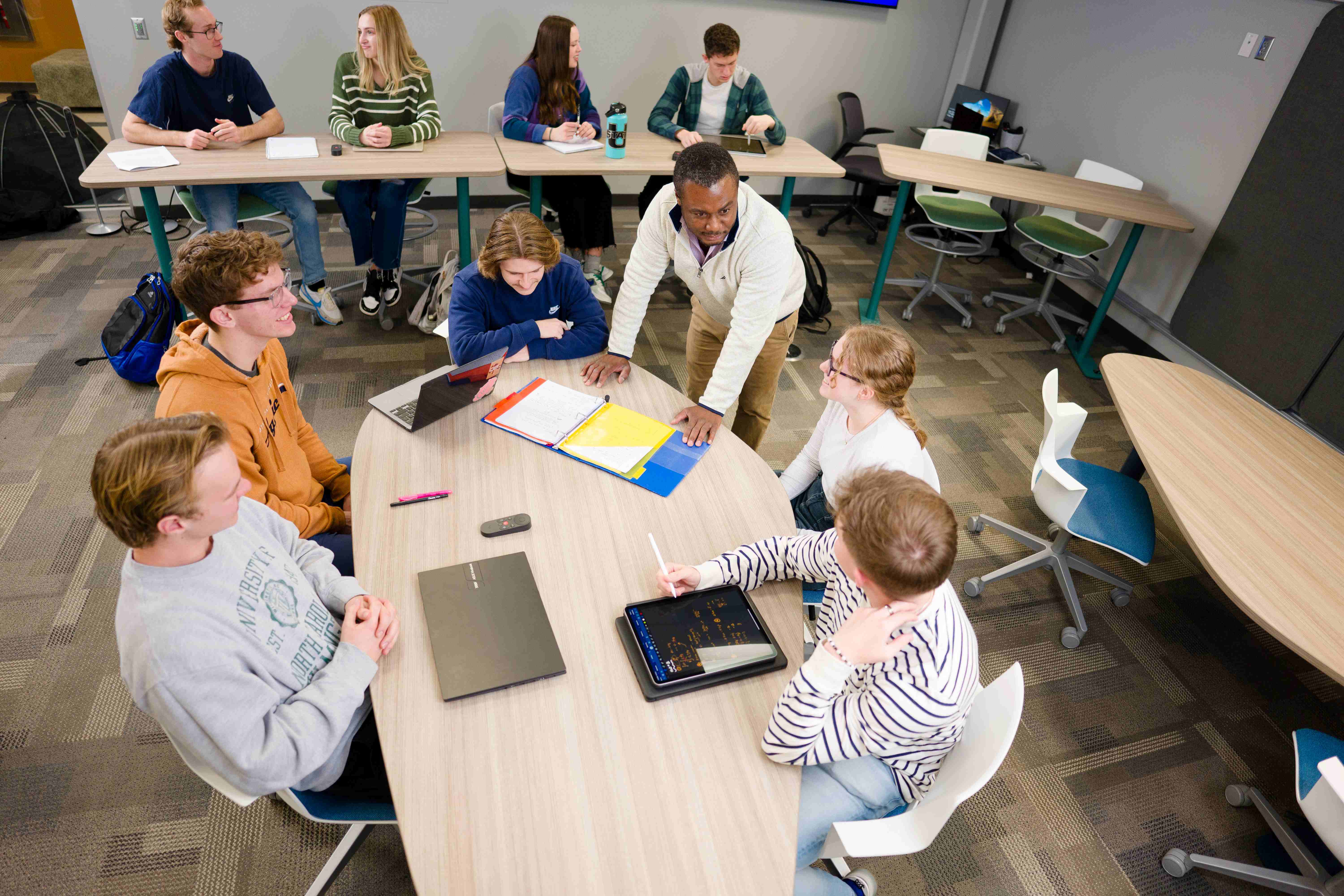 Students sitting around table in classroom