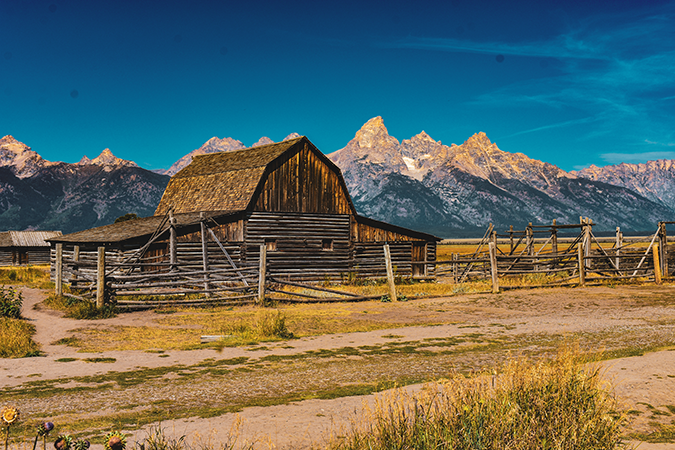 striking landscape of a barn framed by the Teton Mountain Range.